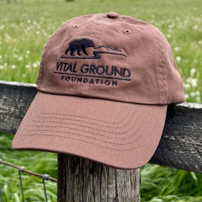 a brown cotton hat with a black Vital Ground logo